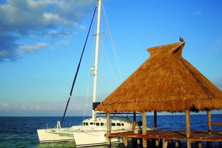 The private catamaran docked at the end of the pier